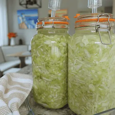 sauerkraut lacto fermented in fermenting mason jars and tea towel