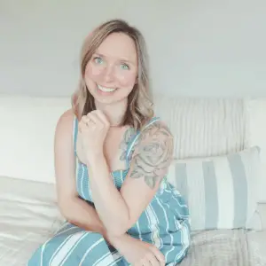 Healthfully rooted home author woman with rose tattoo and blue striped sundress