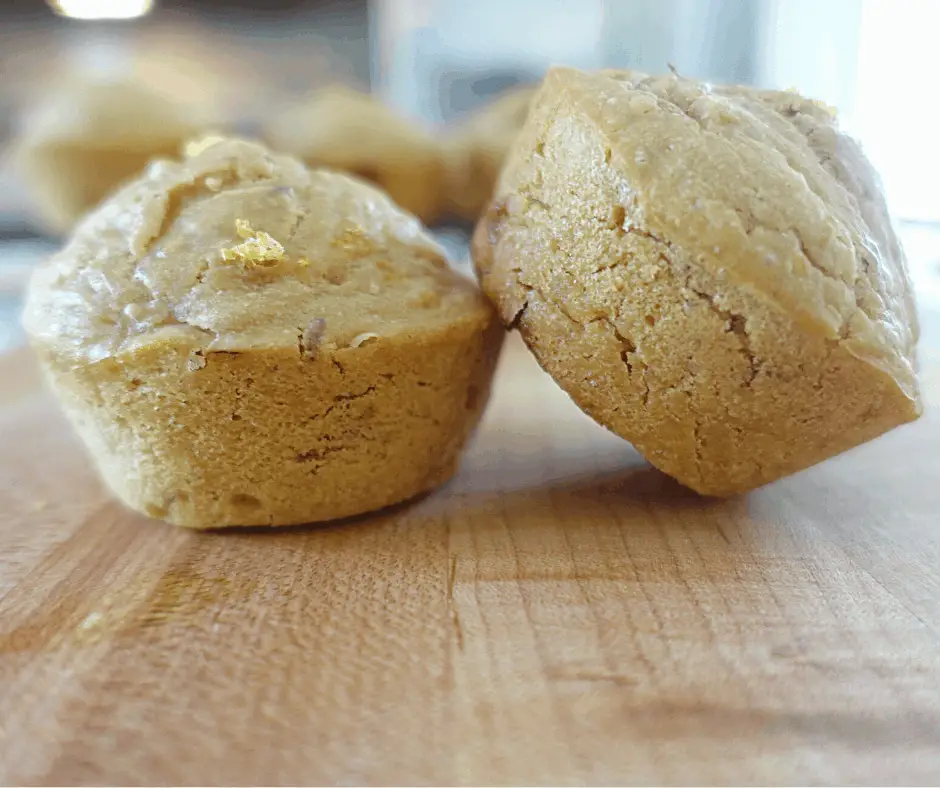 lemon and lavender sourdough discard muffins leaning on one another with lemon zest on top