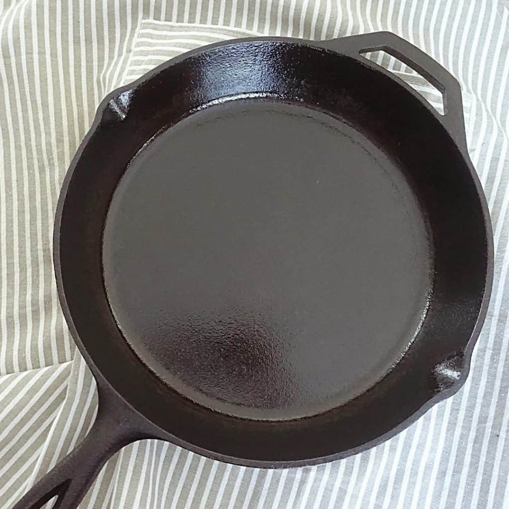 nonstick cast iron skillet over top an apron