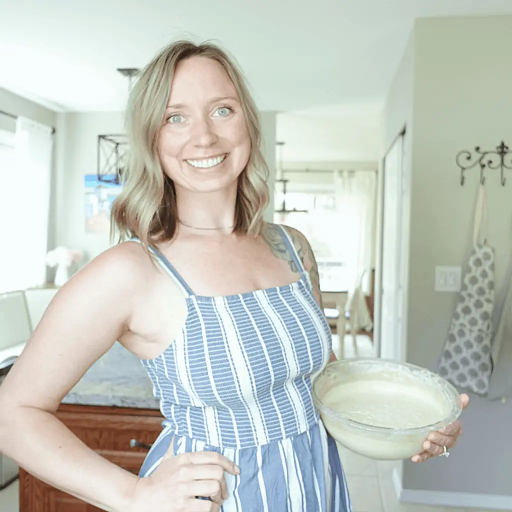 einkorn flour sourdough starter healthfully rooted home holding bowl of sourdough starter in blue dress