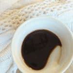 cardamom french press coffee in a clay mug with cozy sweater