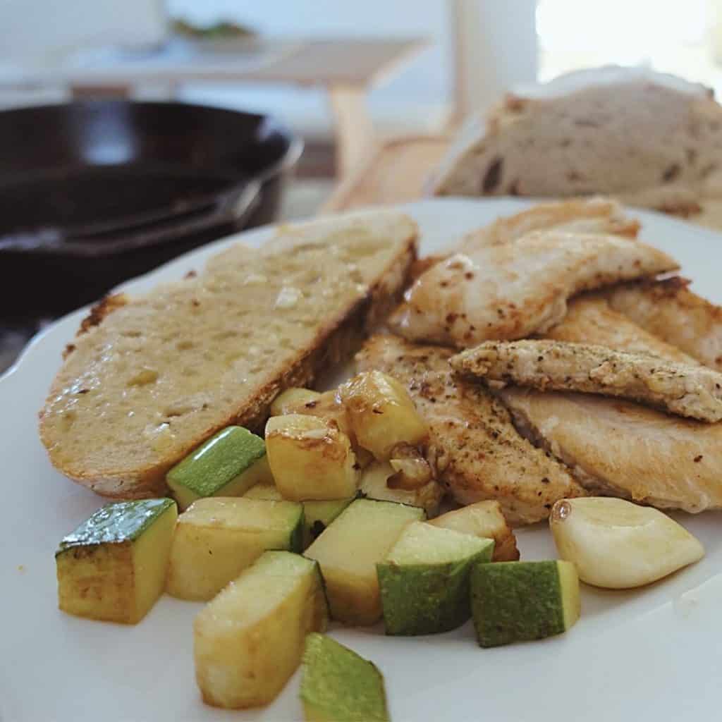 cast iron ghee basted chicken with zuchinni and sourdough bread