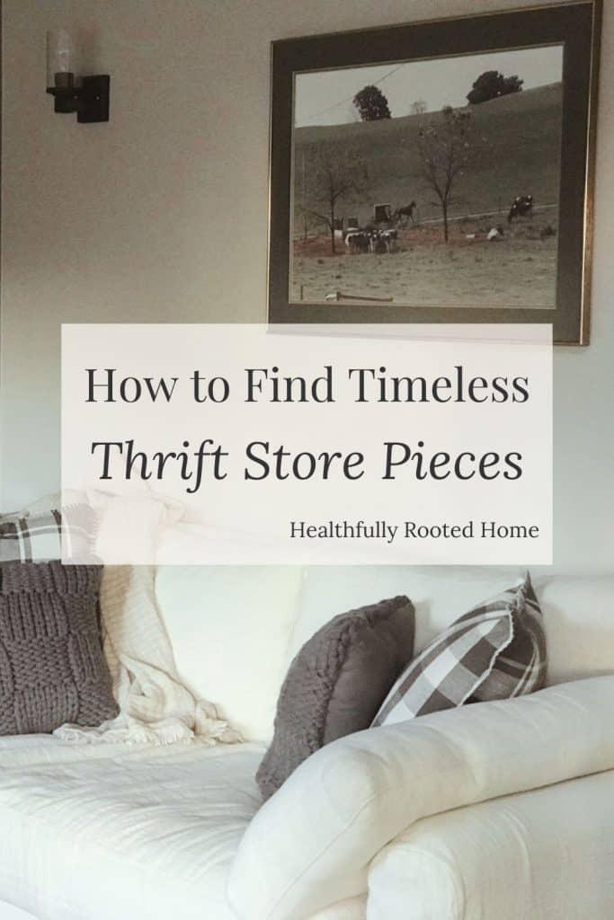 how to find timeless pieces at thrift stores white couch with grey pillows and an amish scene picture frame above the couch