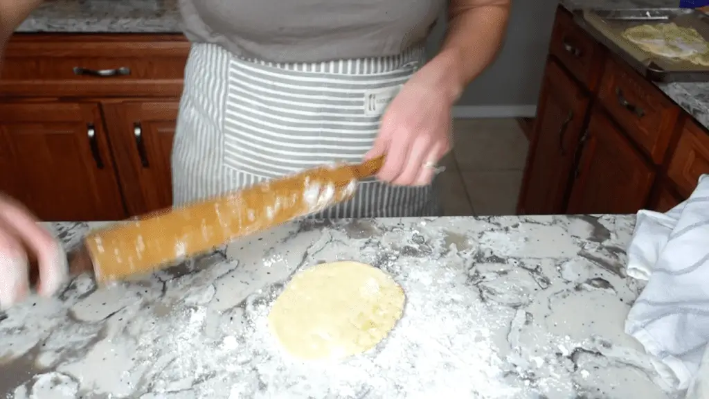 using a rolling pin to roll out einkorn tortillas