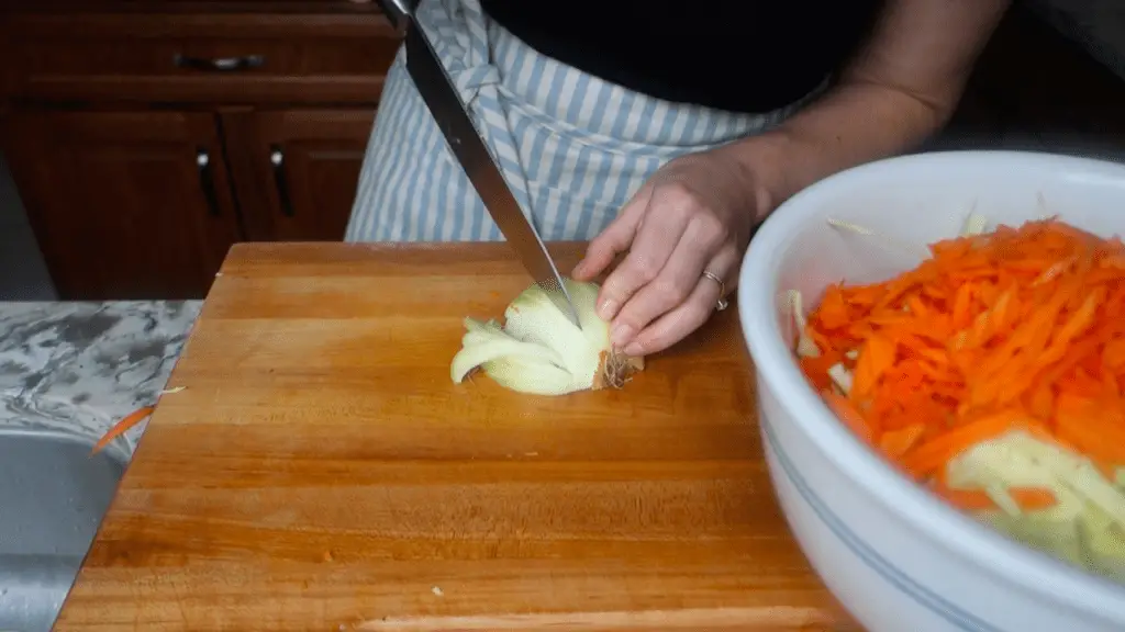 thinly slicing an organic yellow onion