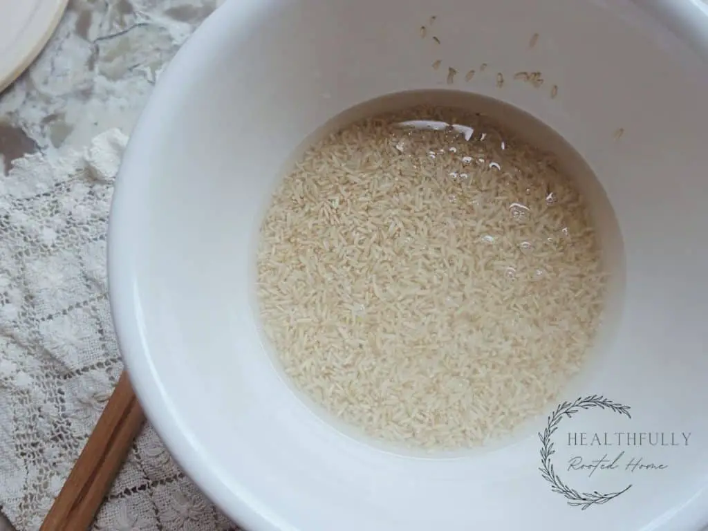 rice soaking in a large bowl with filtered water