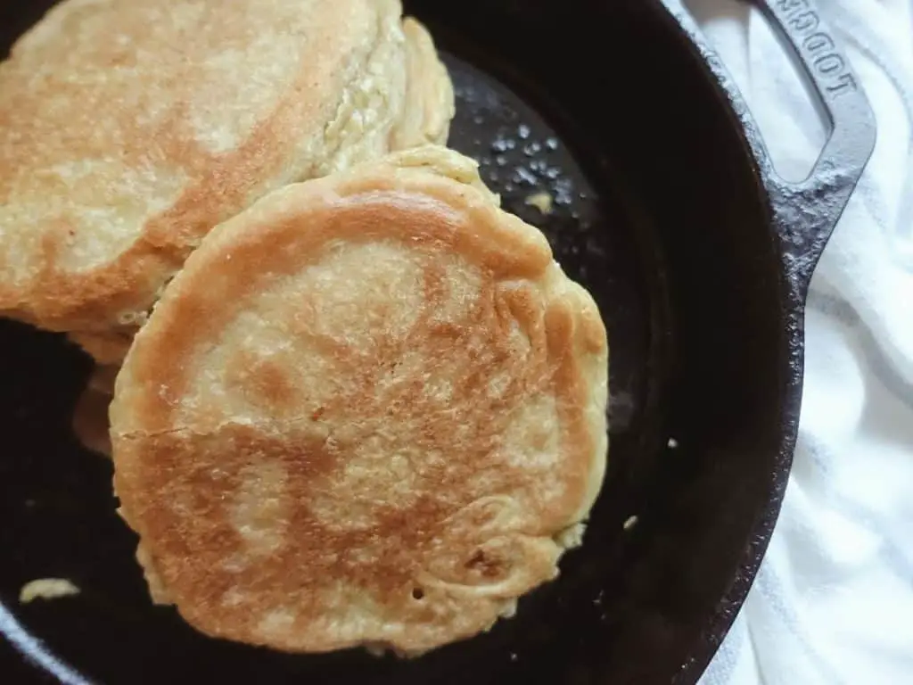 fluffy sourdough pancakes in a cast iron skillet