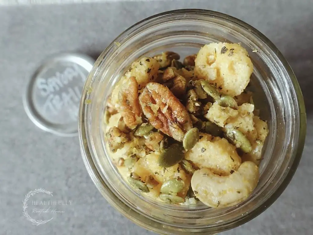 savory trail mix with cheese crisps pecans cashews pepitas and herbs in a mason jar
