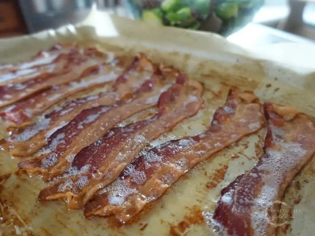 crispy bacon on a parchment lined baking sheet
