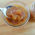fermented mango chutney in a mason jar with a spoon