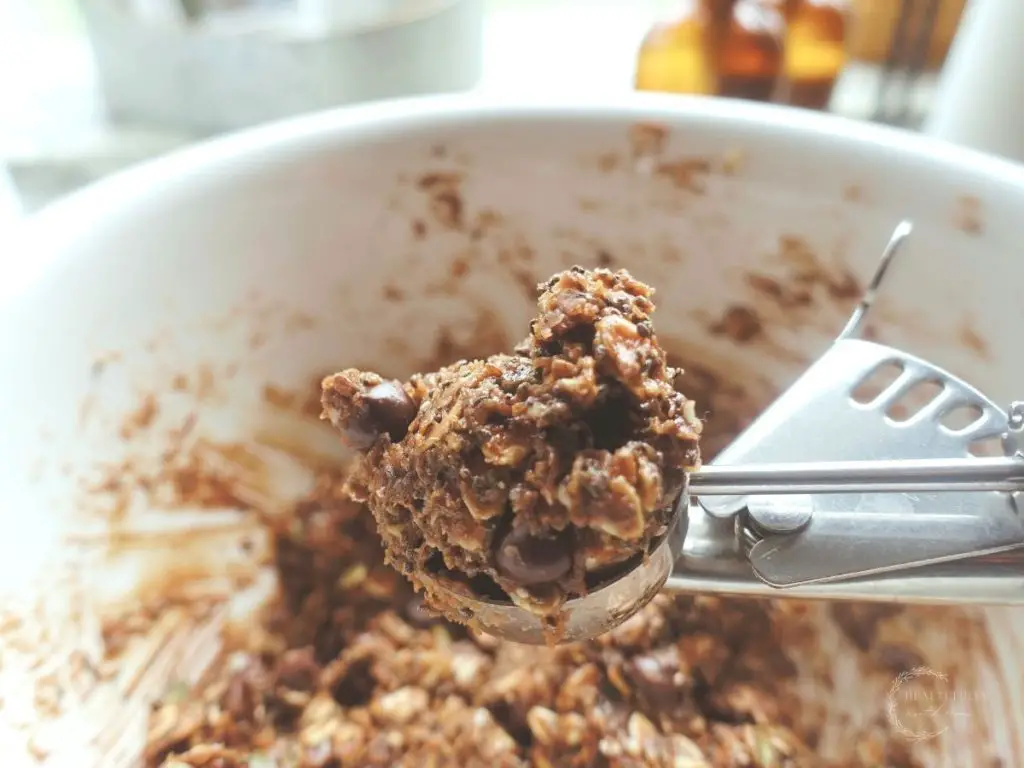 cookie scoop being used to scoop peanut butter bliss balls