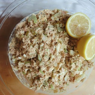 southern tuna salad with dill aioli with two lemons as garnish in a clear bowl