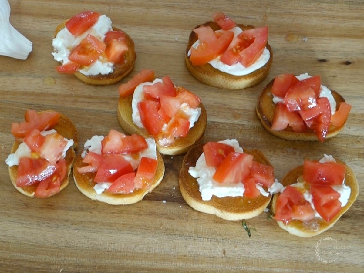burrata cheese on a toasted crostini topped with tomatoes