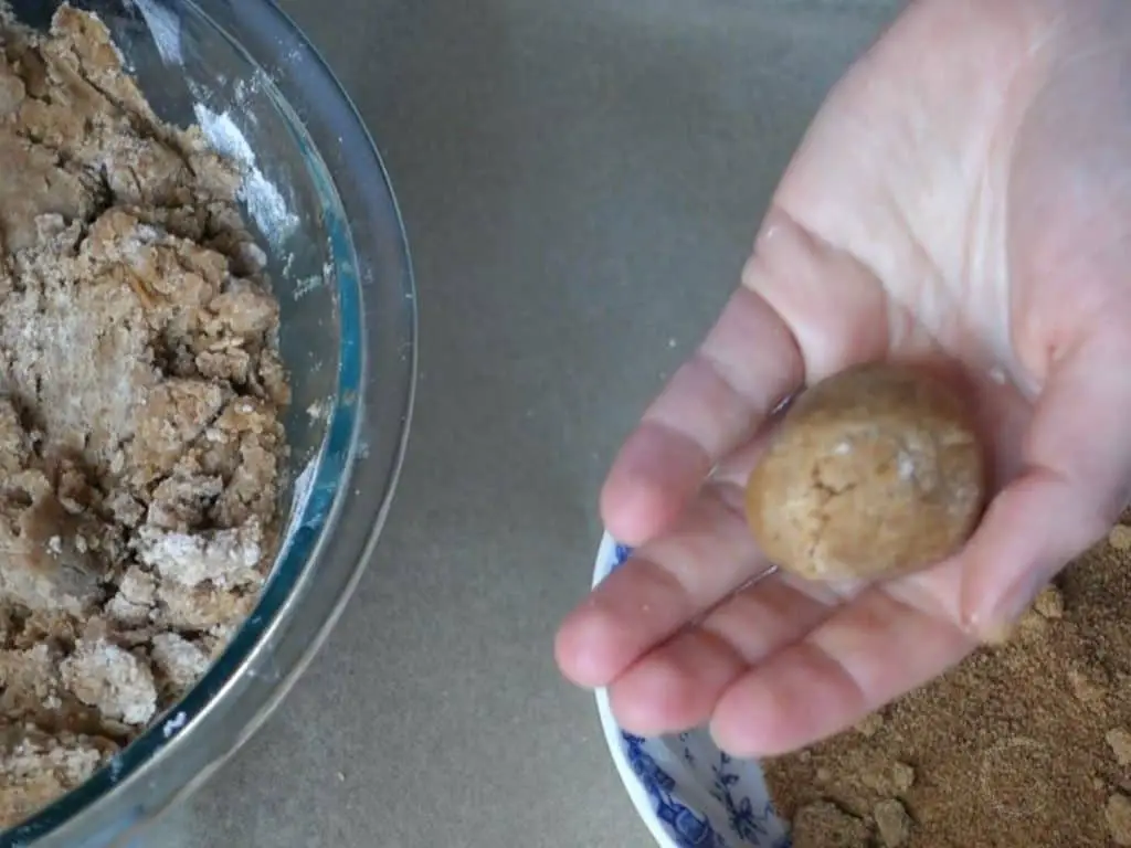 peanut butter cookie dough rolled into a ball 