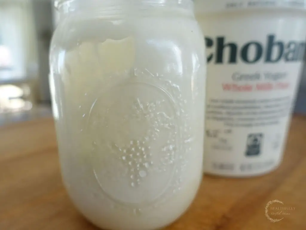 honey cream sauce with chobani greek yogurt in the background and cream sauce in a mason jar