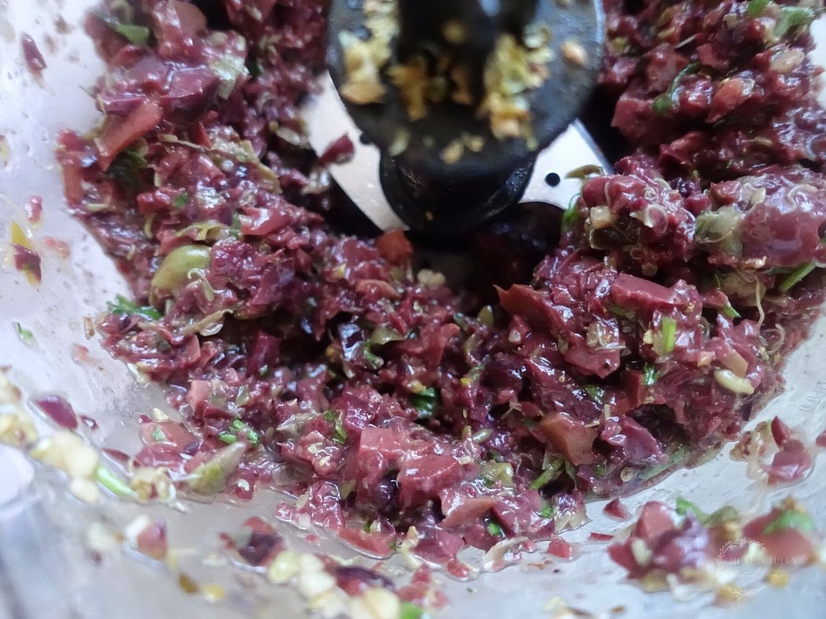 olive tapenade in a food processor with the blade in the center