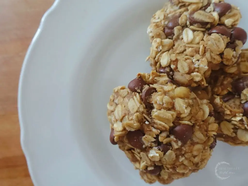 healthy oatmeal cookies on a white plate stacked on top eachother
