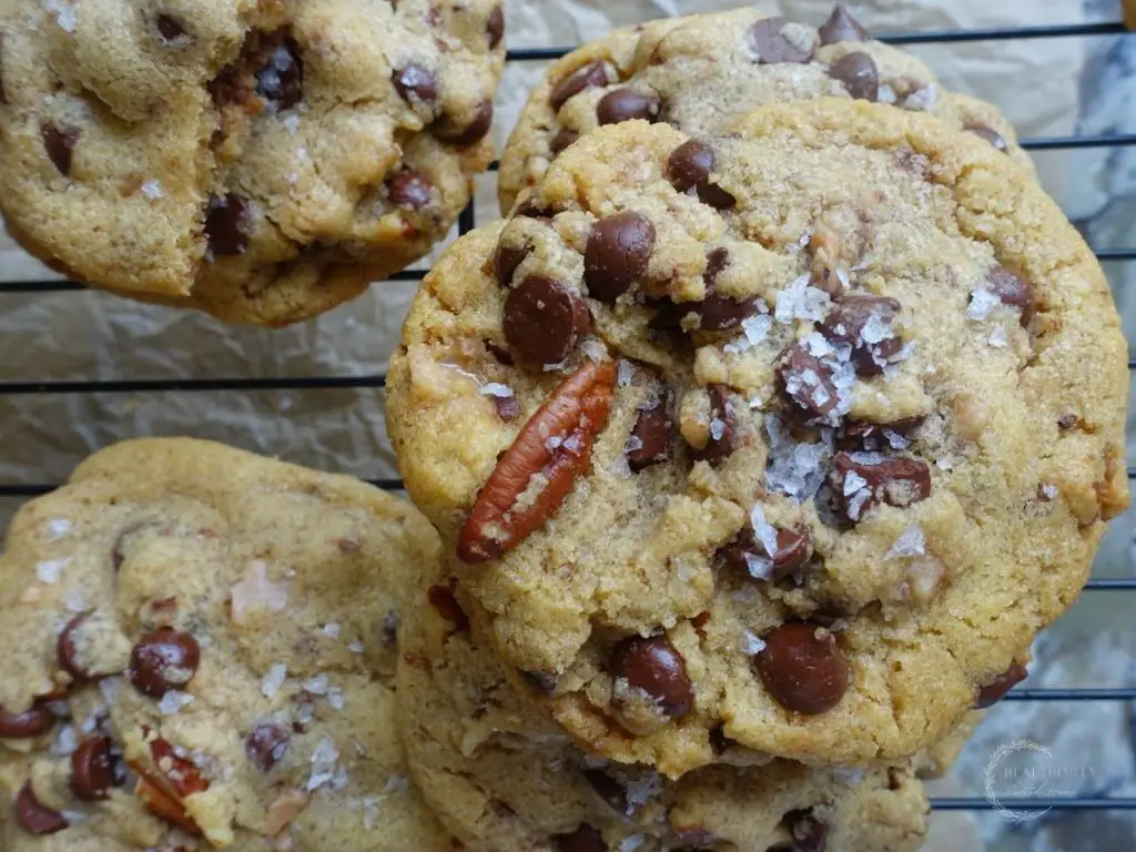 maple chocolate chip cookies on a cooling rack stacked on top eachother