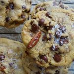 maple chocolate chip cookies on a cooling rack stacked on top eachother