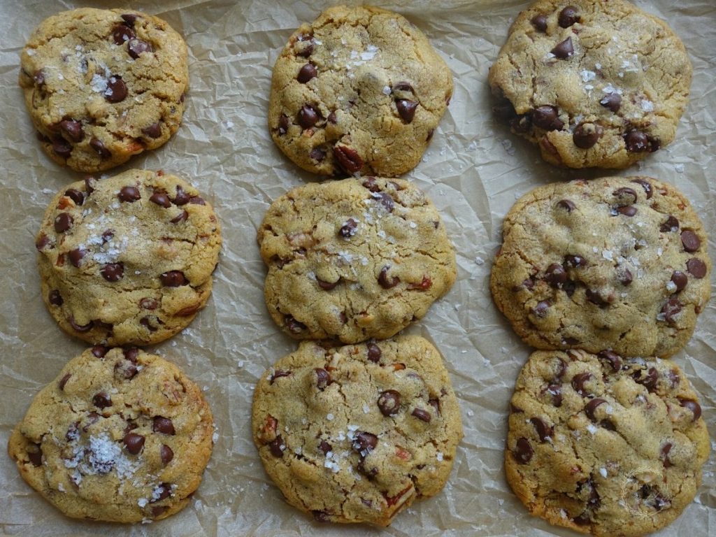 maple chocolate chip cookies on a parchment lined baking sheet