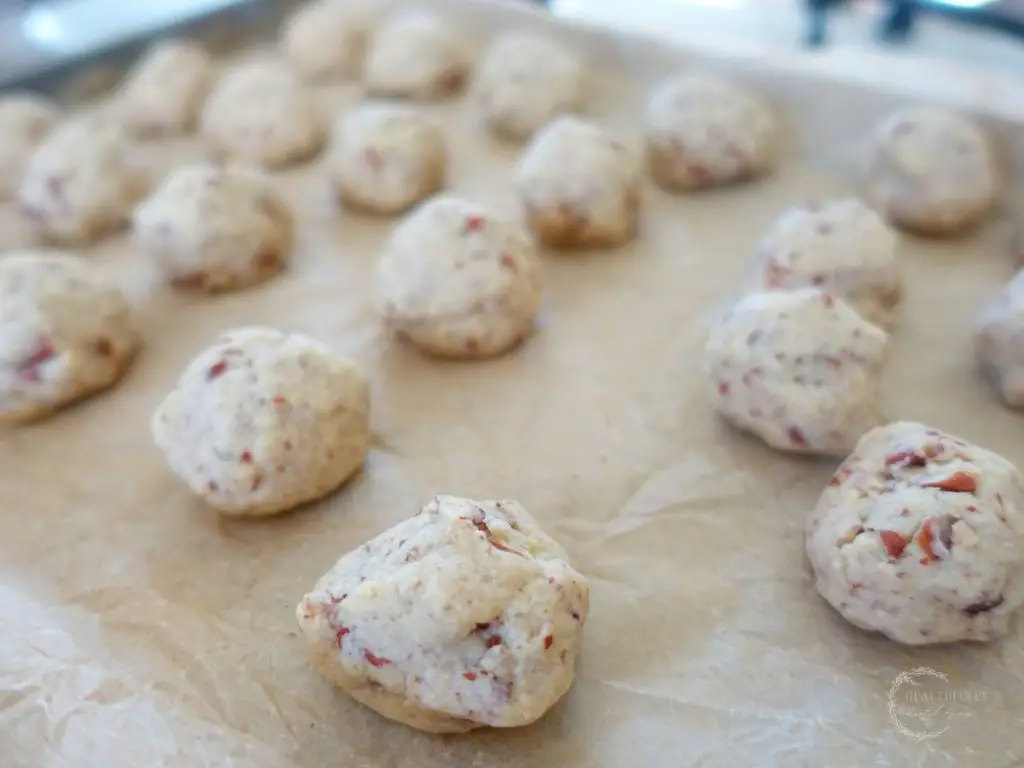 pecan meltaway dough balls on a baking sheet lined with parchment paper