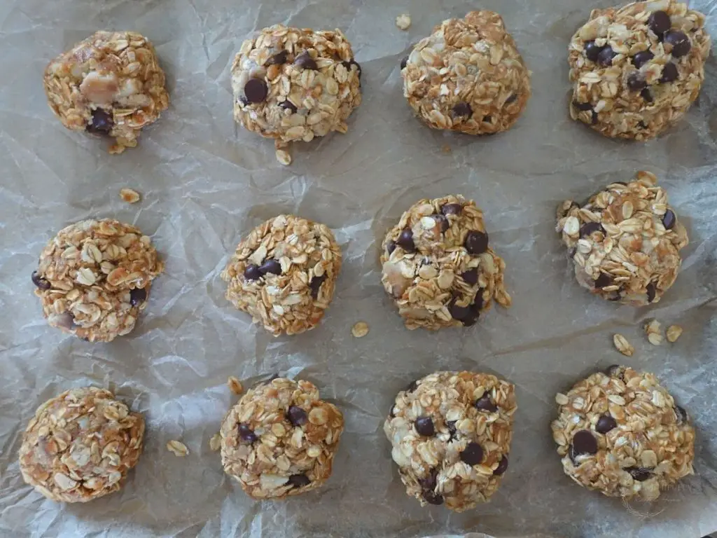 shaped 4 ingredient oatmeal cookies on a baking sheet ready for baking