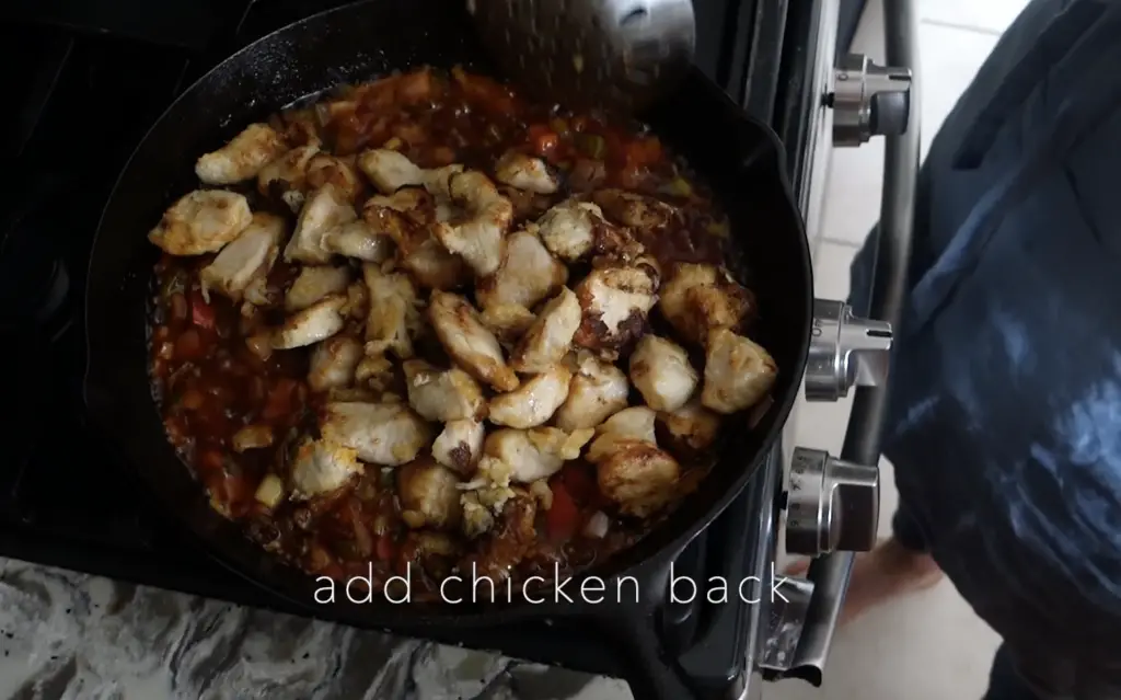 chicken manchurian fried chicken tossed into the cast iron skillet with the sauteed vegetables and manchurian gravy