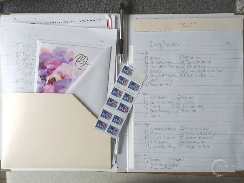 modern homemaking binder with a notepad of daily schedule, to do lists, stamps and birthday cards