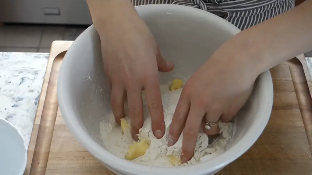 crumbling together the butter into the dry ingredients to make the dough for lemonade scones no cream
