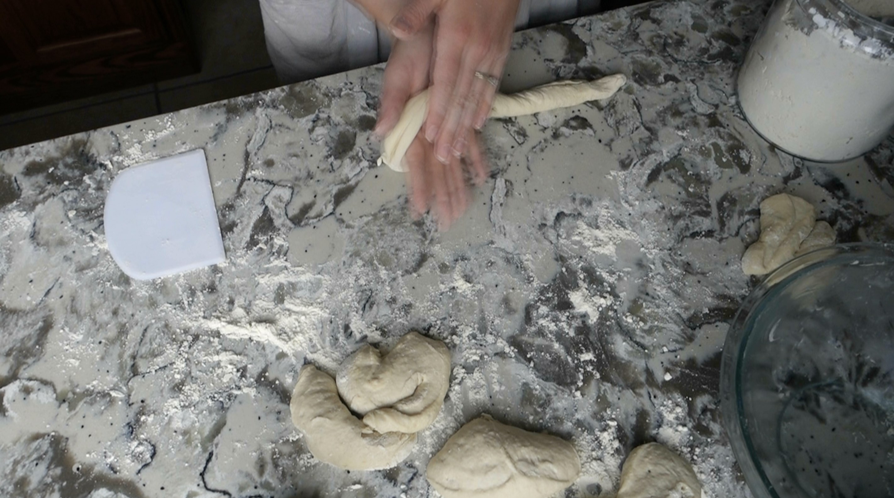 using hands to roll sourdough pretzel dough