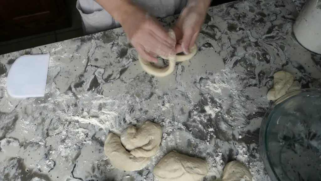 shaping sourdough pretzel dough into the shape of a pretzel