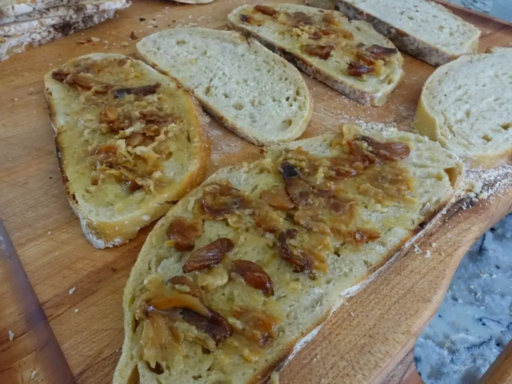 sourdough bread slices with garlic confit spread on top