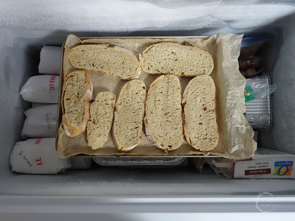 tray of sourdough bread slices in a deep freezer for a quick freeze