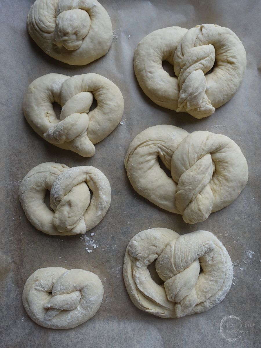 pretzel dough before the final rise after being shaped and placed on a baking sheet