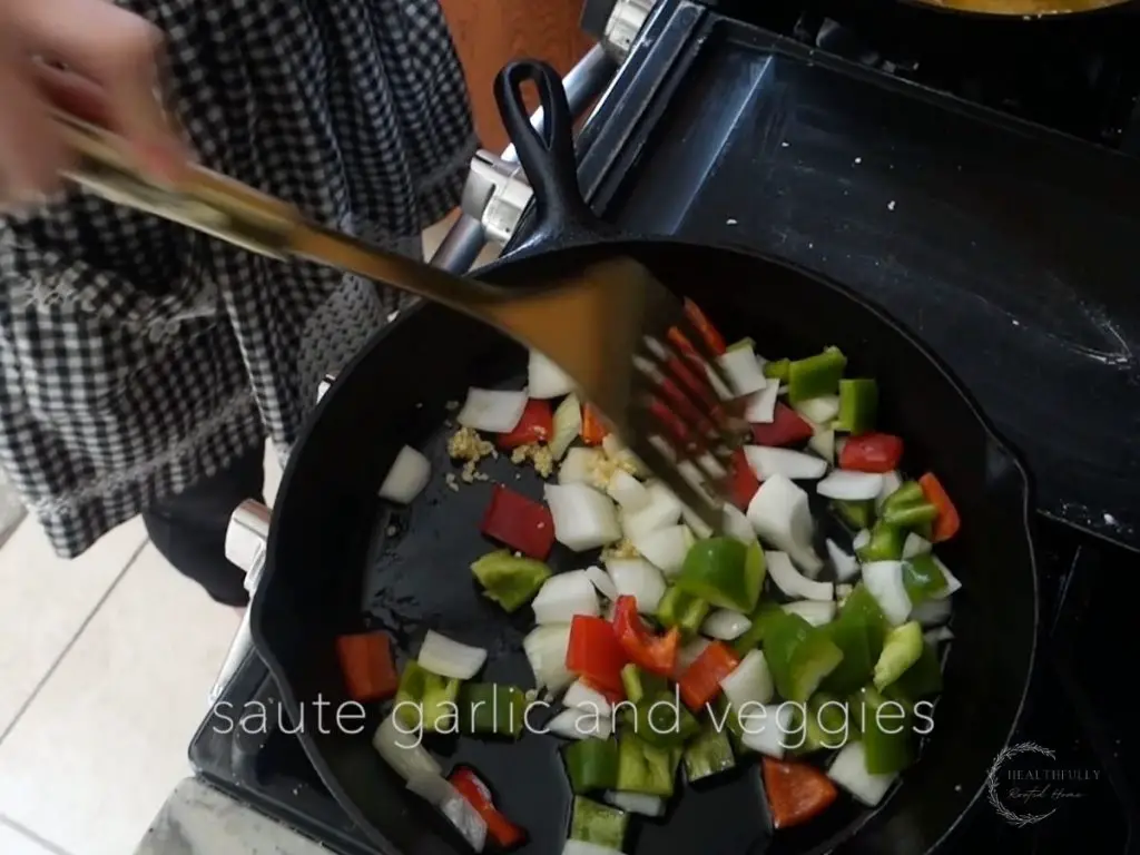 sauteeing vegetables in a cast iron skillet and tossing with a gold spatula