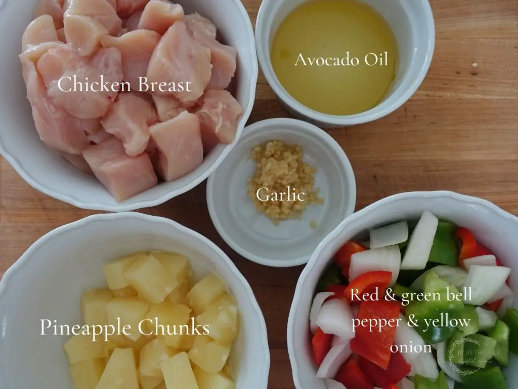 stir fry ingredients for sweet and sour chicken in white bowls and labels so you can see what each item is