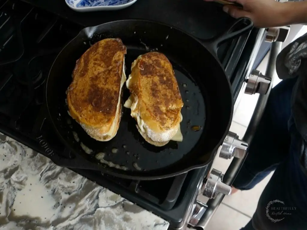browned ancho aioli grilled cheese sandwiches in a cast iron skillet