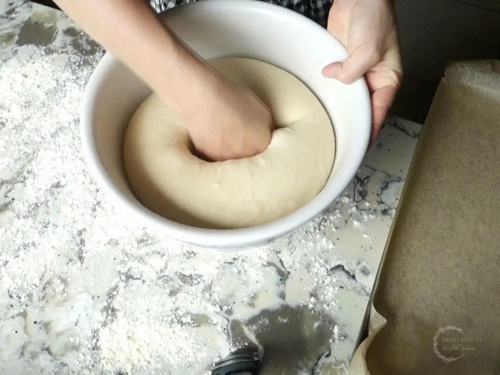 punching sourdough discard bagel dough down