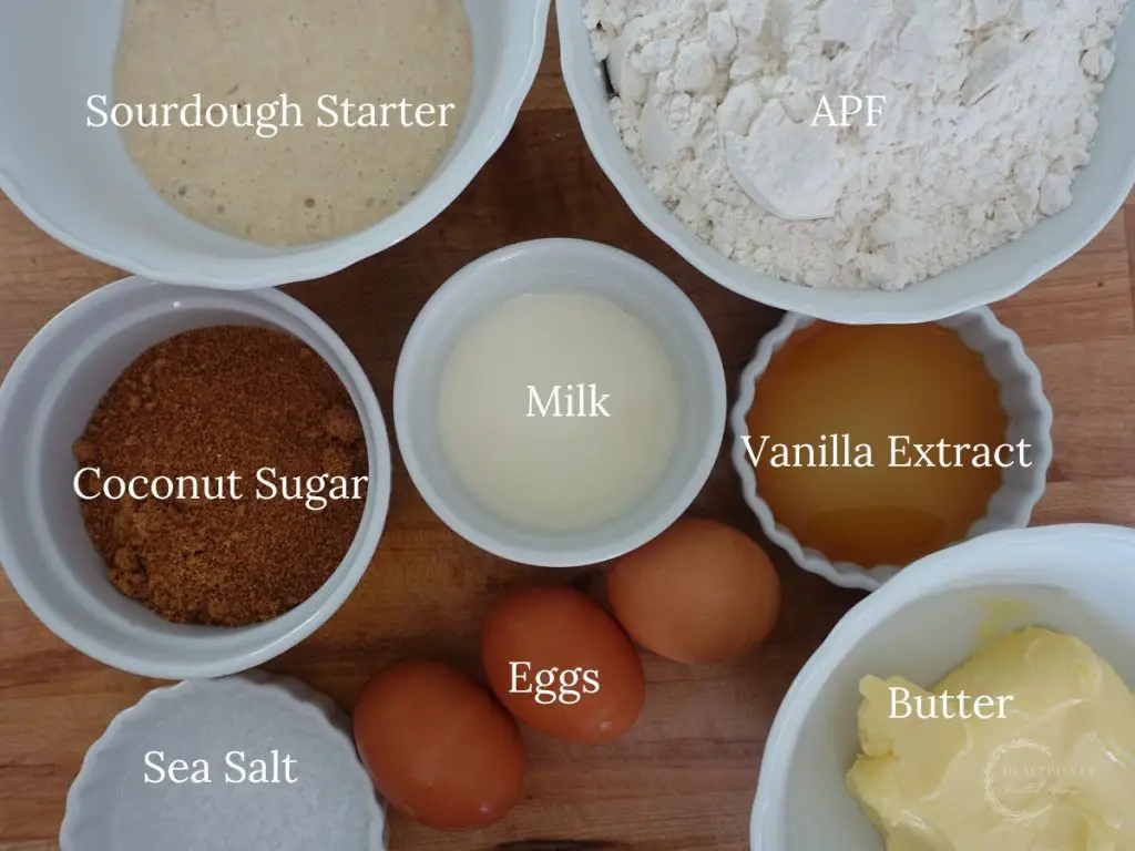 all the ingredients used to make sourdough babka dough in white bowls with labels saying what they are