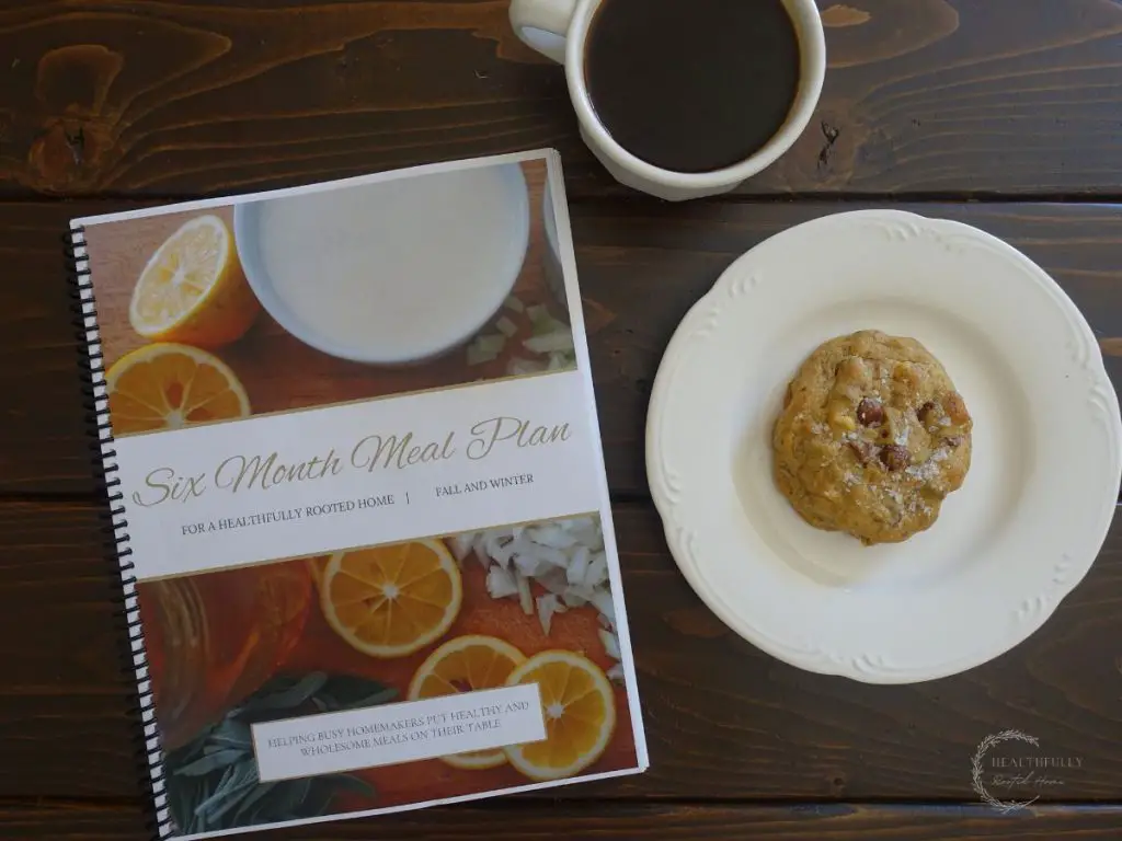 fall and winter meal plan book with a cookie and coffee next to it