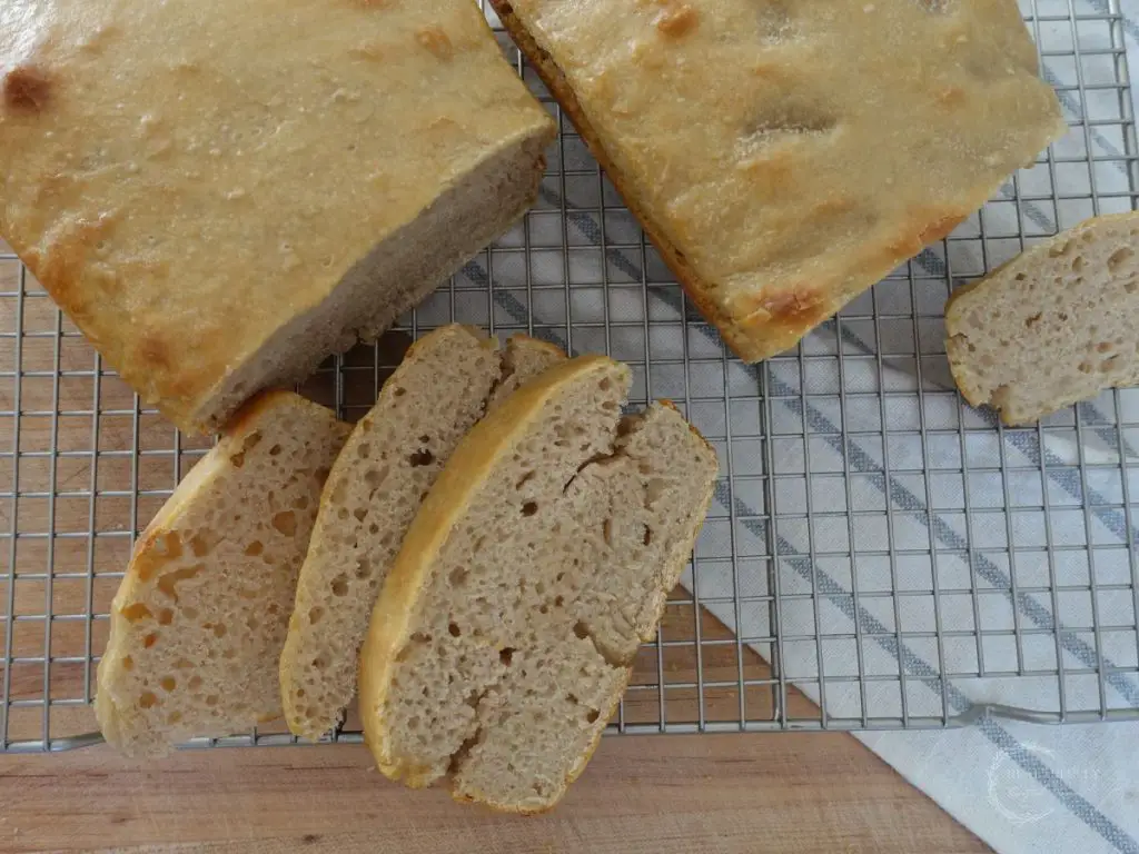 long fermented sandwich bread after being baked with slices on the side