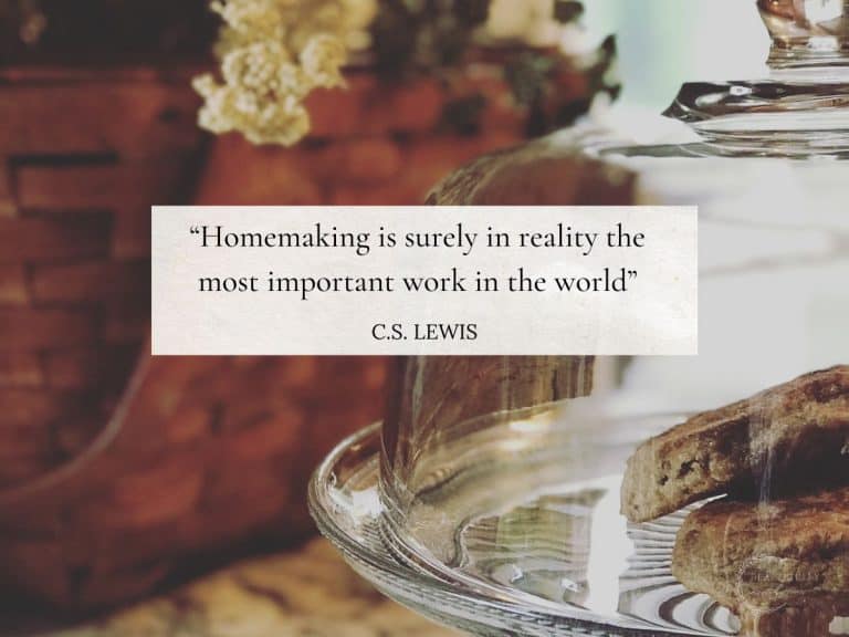 cake stand with sourdough english muffins inside next to a picnic basket with stems on top displaying a homemaking quote