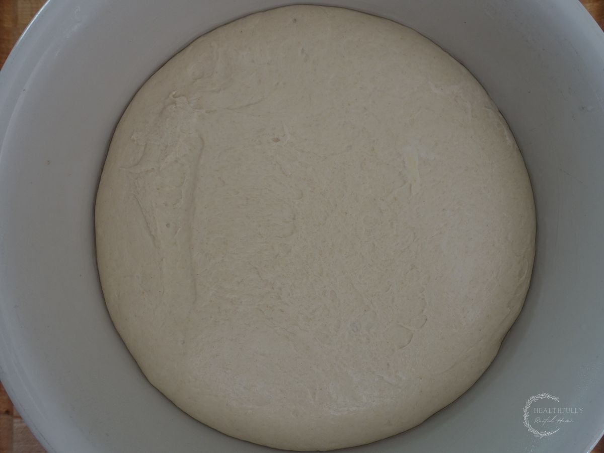 fermented bread dough in a large bowl doubled in size