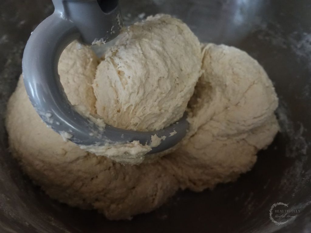 fermented dough in a stand mixer with a dough whisk showing how to read the dough