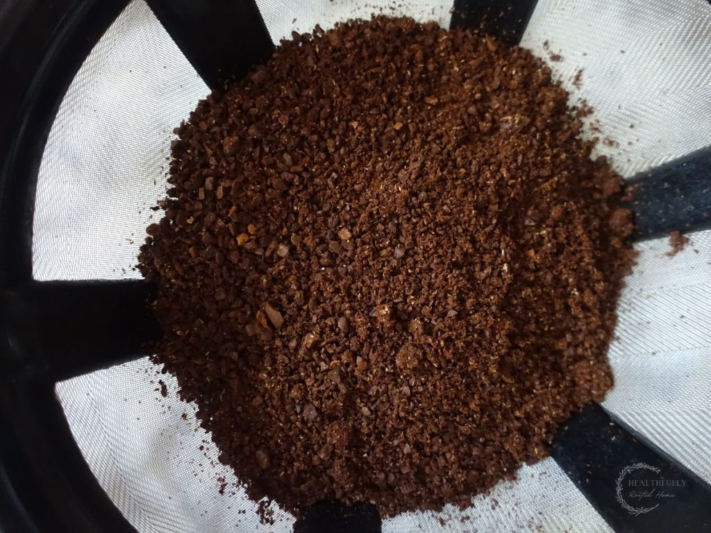 sea salt coarseness of ground coffee beans in the filter of a hand drip coffee maker