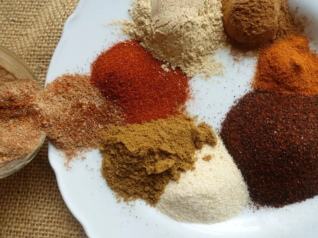 low sodium taco seasoning with all the spices to make the recipe on a white plate