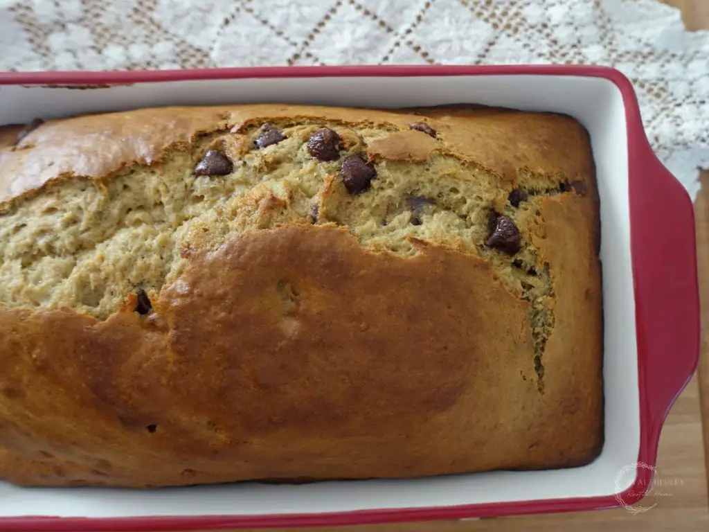 baked sourdough discard banana bread in a red loaf pan