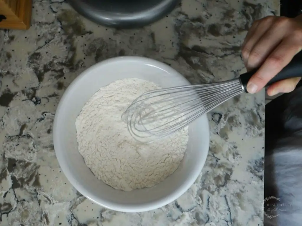 mixing dry ingredients for sourdough discard banana bread in a separate bowl