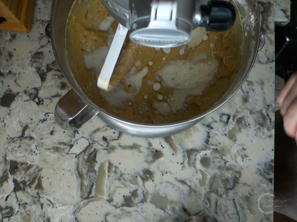 melted coconut oil added to the sourdough discard banana bread batter in a stand mixer